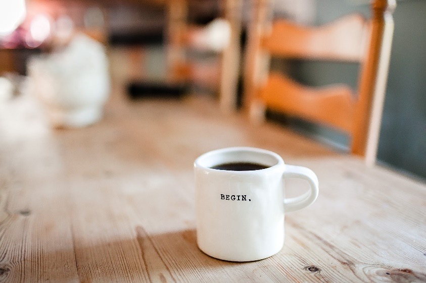 a cup of coffee in a wooden table